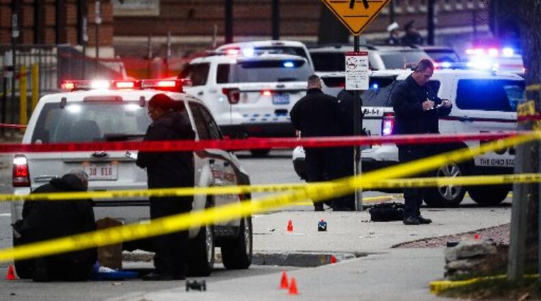 Crime scene investigators collect evidence from the pavement as police respond to an attack on campus at Ohio State University, Monday, Nov. 28, 2016, in Columbus, Ohio. (AP Photo/John Minchillo)