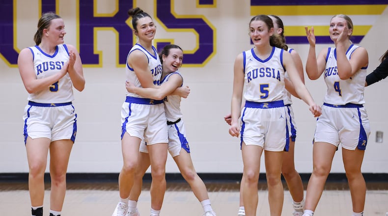 Russia senior guard Kourtney Phlipot (center right) hugs senior center Kora Doseck after the Raiders beat Cedarville 40-32 in a Division VII regional final on Saturday, March 7 at Vandalia-Butler's Student Activity Center. BRYANT BILLING / STAFF