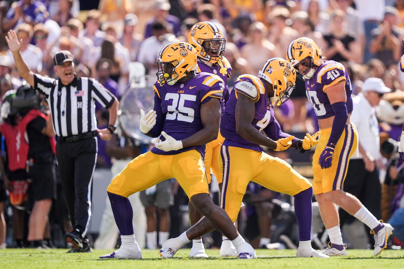 LSU defensive end Bradyn Swinson (4) and defensive end Sai'vion Jones (35) celebrate a sack in the first half of an NCAA college football game against UCLA in Baton Rouge, La., Saturday, Sept. 21, 2024. (AP Photo/Gerald Herbert)