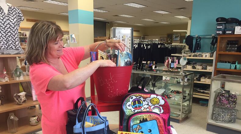 Wright-Patterson Air Force Base Thrift Shop Manager Paula Cardenas prepares a display of items. (Skywrighter photo/Amy Rollins)