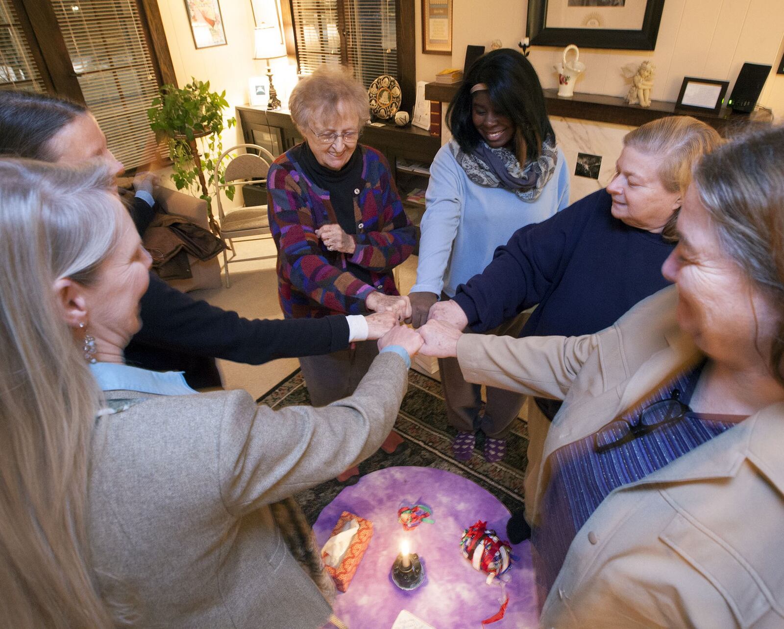 Sister Rose Martin Morand, center-left, leads a program that makes Peace Circles for women inmates in the Montgomery County Jail to help support the women. This gathering is at the Baha’i Center in Dayton.