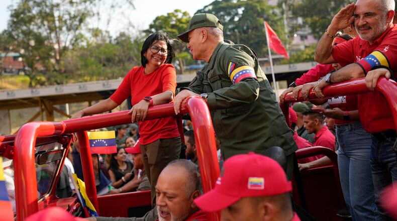 FILE - Vice President Delcy Rodriguez, left, smiles at Venezuelan Defense Minister Padrino Lopez, as they take the route that the body of late President Hugo Chavez was transported to his final resting place, during the activities marking the 10th anniversary of Chavez's death, in Caracas, Venezuela, March 15, 2023. (AP Photo/Matias Delacroix, File)