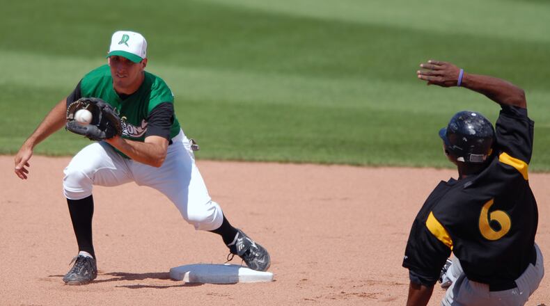 Dayton Dragons shortstop Adam Rosales tags out South Bend’s Justin Upton on a steal attempt on June 25, 2006, at Fifth Third Field. STAFF FILE PHOTO
