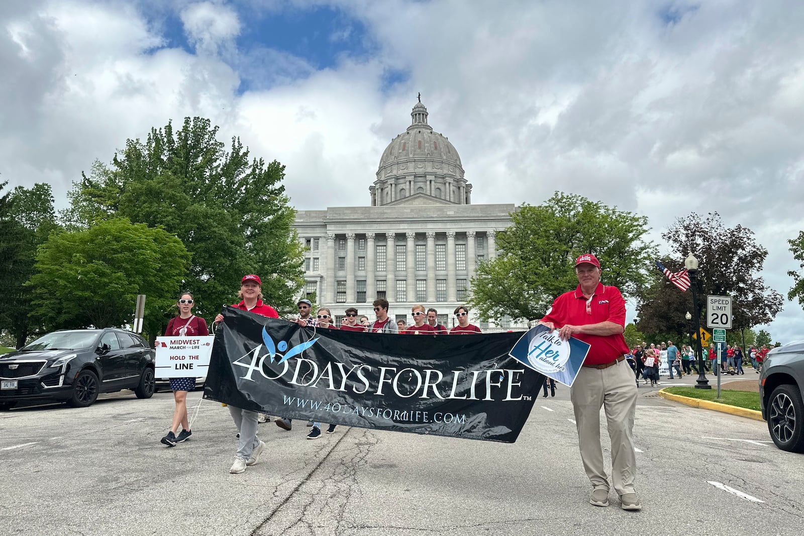 Participants in the Midwest March for Life walk through the streets of Jefferson City, Mo., with the state Capitol in the background on May 1, 2025. (AP Photo/David A. Lieb)