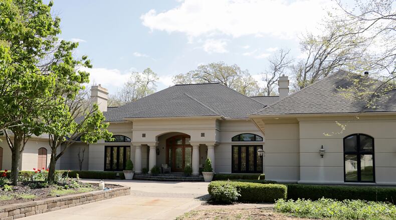 Offering about 8,490 sq. ft. of living space, the 5-bedroom home includes volume ceilings, marble floors, a walk-out lower level and a 3-car garage. A screen-enclosed porch is accessible from the kitchen. CONTRIBUTED PHOTO BY KATHY TYLER
