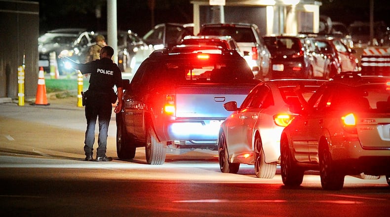 A line of cars waits to enter a Wright-Patterson Air Force Base gate in this 2021 file photo. (Marshall Gorby/Staff)