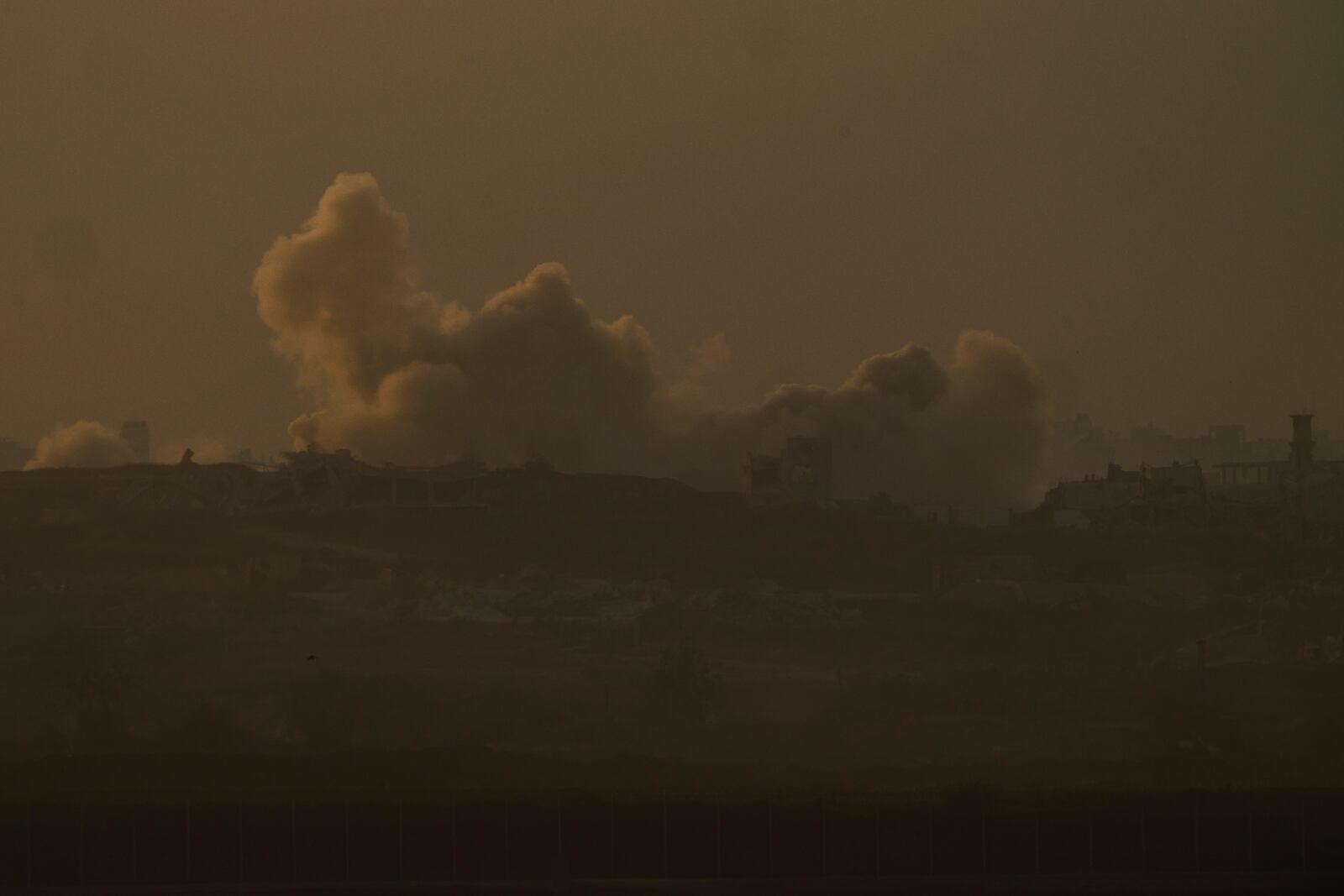 Smoke from Israeli bombardment billows over the Gaza Strip, seen from southern Israel, Wednesday, June 11, 2025. (AP Photo/Ariel Schalit)