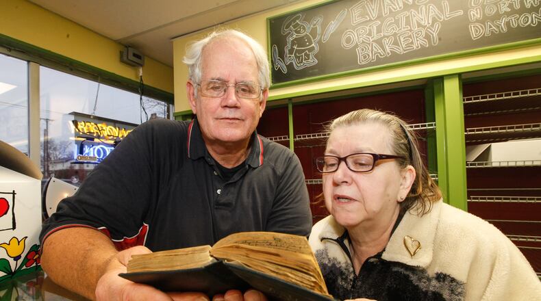 Roger Luther, left, an elder at the Second Presbyterian Church in Portsmouth, traveled to Dayton on Friday to pick up a diary of former church member Lena O’Mara, which was deposited by a tornado in the yard of Linda Porter, right. CHRIS STEWART / STAFF