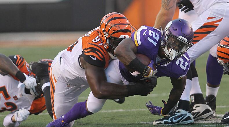 CINCINNATI, OH - AUGUST 12: Jerick McKinnon #21 of the Minnesota Vikings runs the football upfield against Marcus Hardison #21 of the Cincinnati Bengals during their game at Paul Brown Stadium on August 12, 2016 in Cincinnati, Ohio. The Vikings defeated the Bengals 17-16. (Photo by John Grieshop/Getty Images)