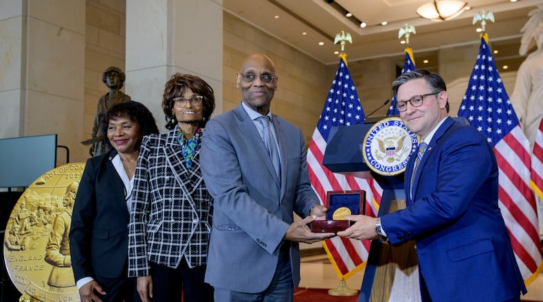 House Speaker Mike Johnson, R-La., right, presents the Congressional Gold Medal to Stanley Earley III, son of Lt. Col. Charity Adams Earley, second from right, her daughter Judith Earley, second from left, and retired Army Col. Edna W. Cummings, during a ceremony honoring the Six Triple Eight, on Capitol Hill, Tuesday, April 29, 2025, in Washington. (AP Photo/Rod Lamkey, Jr.)