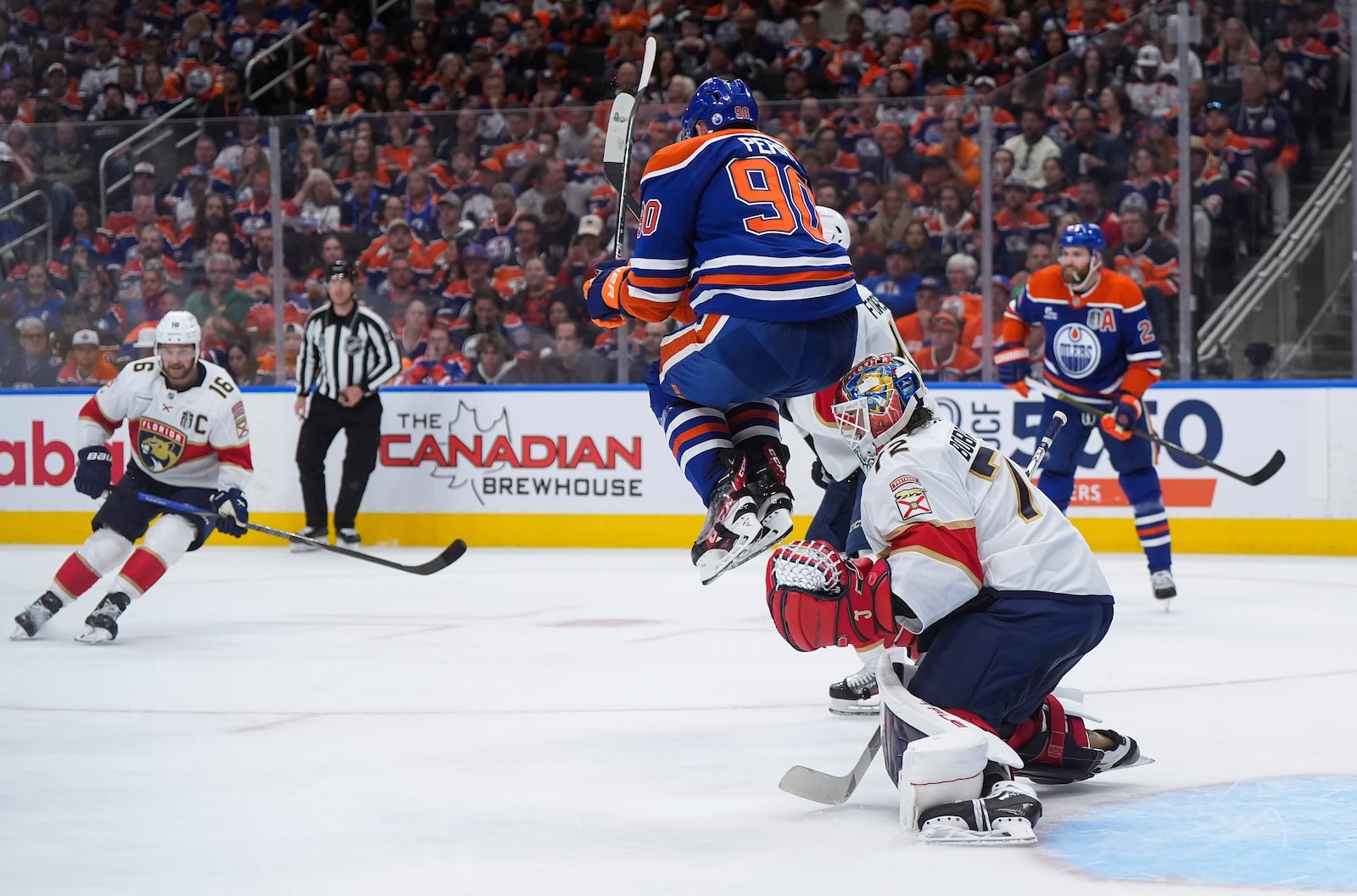 Florida Panthers goalie Sergei Bobrovsky (72) makes the save as Edmonton Oilers' Corey Perry (90) jumps in front of him during the second period in Game 2 of the NHL hockey Stanley Cup Finals, in Edmonton, Alberta, Friday, June 6, 2025. (Darryl Dyck/The Canadian Press via AP)