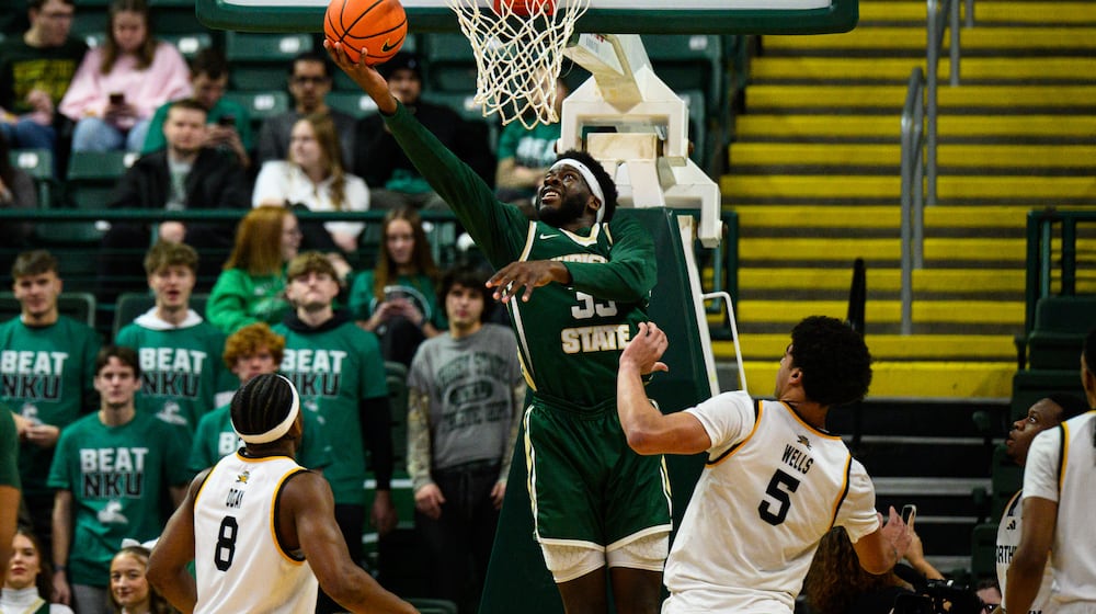 Wright State University's Michael Imariagbe shoots the ball between two Northern Kentucky University defenders during their game on Saturday, Jan. 24, 2026. JEREMY MILLER / CONTRIBUTED PHOTO