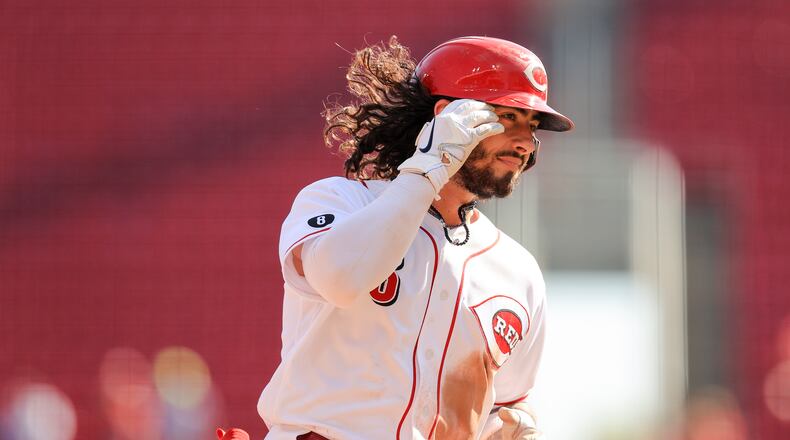 Cincinnati Reds' Jonathan India fixes his hair as he runs the bases after hitting a two-run home run during the seventh inning of a baseball game against the Pittsburgh Pirates in Cincinnati, Monday, Sept. 27, 2021. (AP Photo/Aaron Doster)