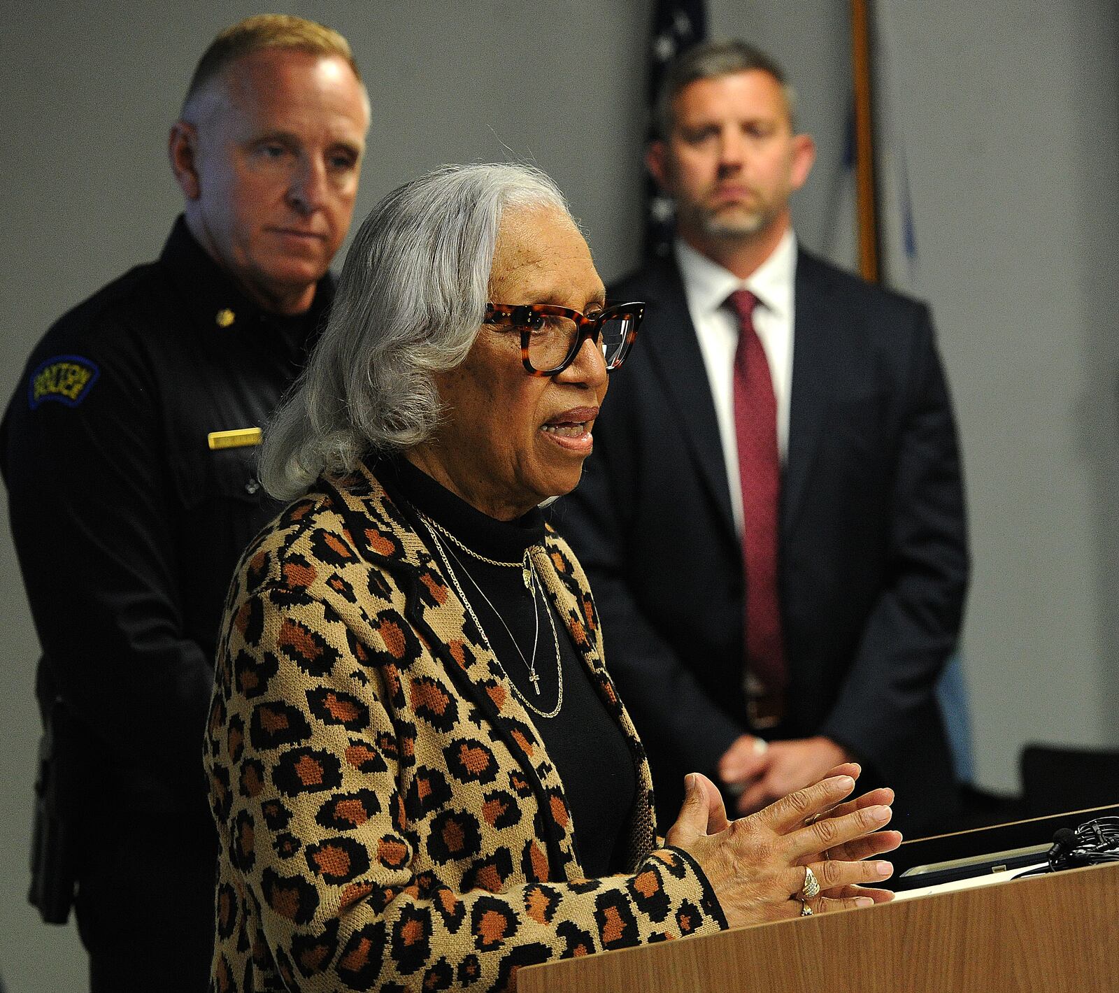Rosemary Brame, the mother of Dayton police officer Kevin Brame who was gunned down in November 1999, speaks during a media briefing Thursday, April 11, 2024, at the Dayton Safety building. In back are Dayton police Maj. Brian Johns, left, and FBI Special Agent in Charge Adam Lawson. MARSHALL GORBY\STAFF