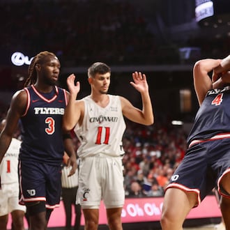 Dayton's Jordan Derkack is fouled by Cincinnati's Baba Miller in the first half on Tuesday, Nov. 11, 2025, at Fifth Third Arena in Cincinnati. David Jablonski/Staff