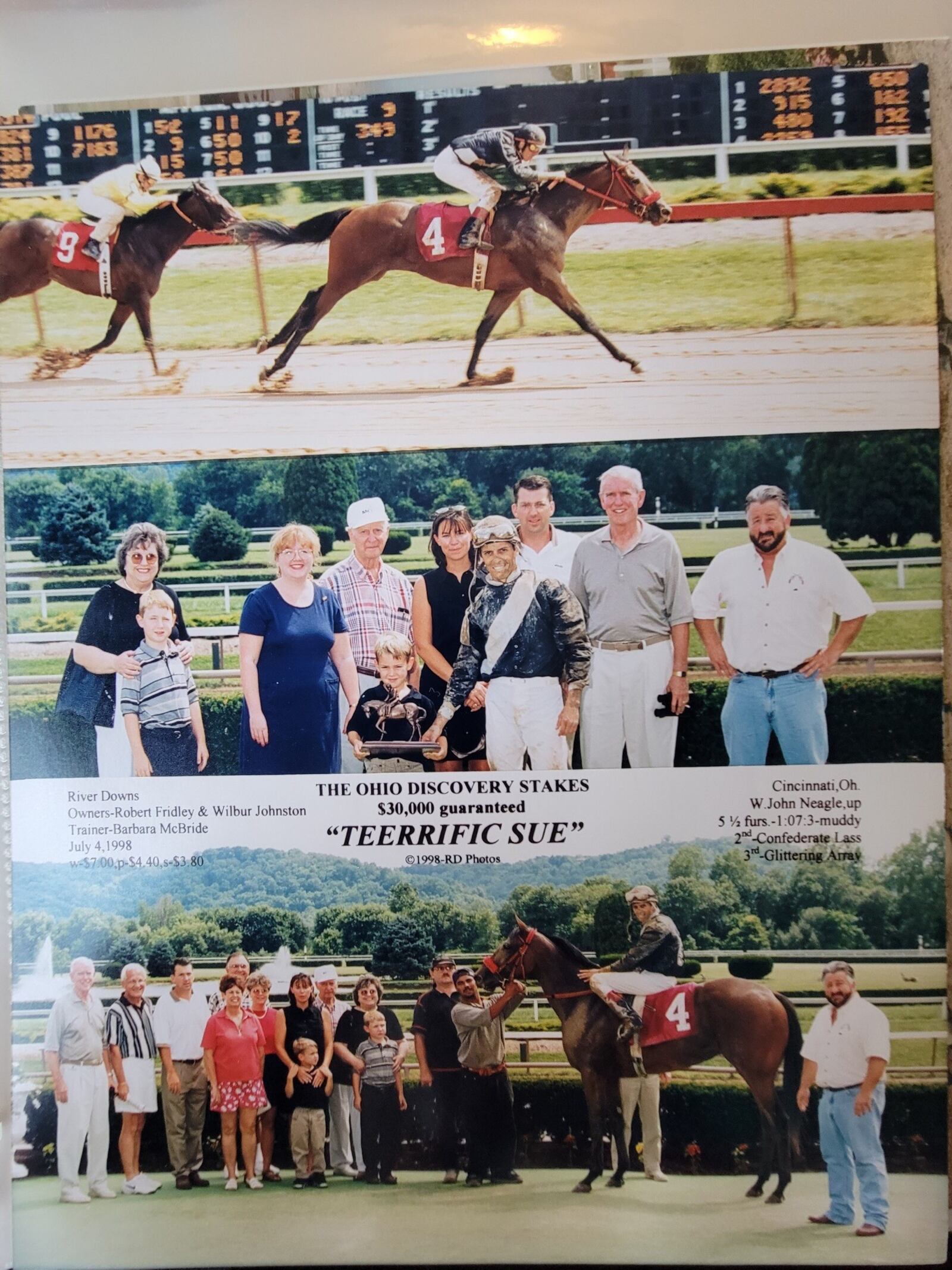 TEERRIFIC SUE in the Winner’s Circle at River Downs after winning The Ohio Discovery Stakes on the Fourth of July in 1998.  Co-owners Wilbur Johnston (second from right), Rob Fridley (third from right) and Rob’s wife Sue (next to him) stand behind victorious and muddied jockey John Neagle, who is holding the race trophy with the Fridley’s youngest son Wil (named after Johnston). Tee Johnston, Wilbur’s wife (far left), is with the Fridley's oldest son, Nate. The winning bay filly was named after Tee and Sue.  (CONTRIBUTED PHOTO)