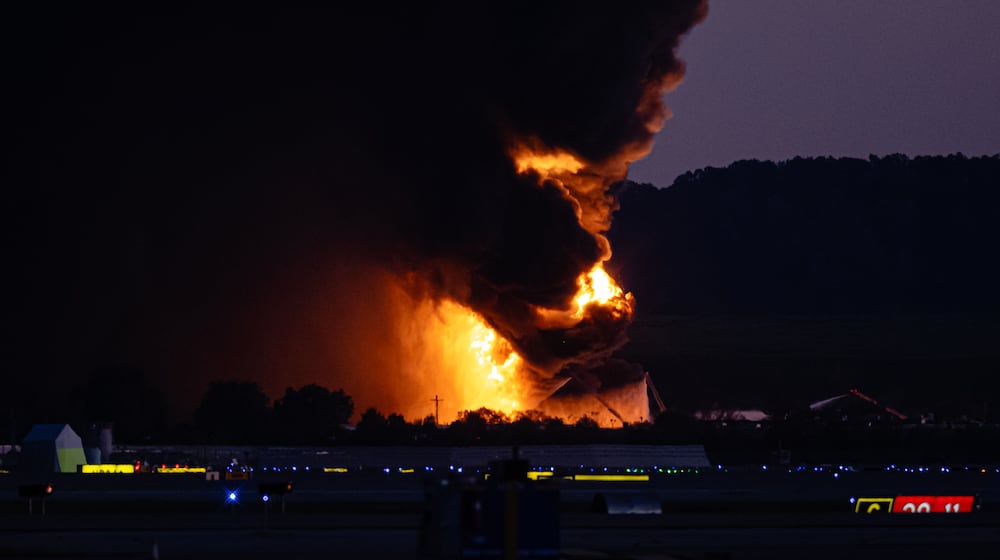 A fireball erupts near airport property after reports of a plane crash at Louisville International Airport, Tuesday, Nov. 4, 2025, in Louisville, Ky. (AP Photo/Jon Cherry)