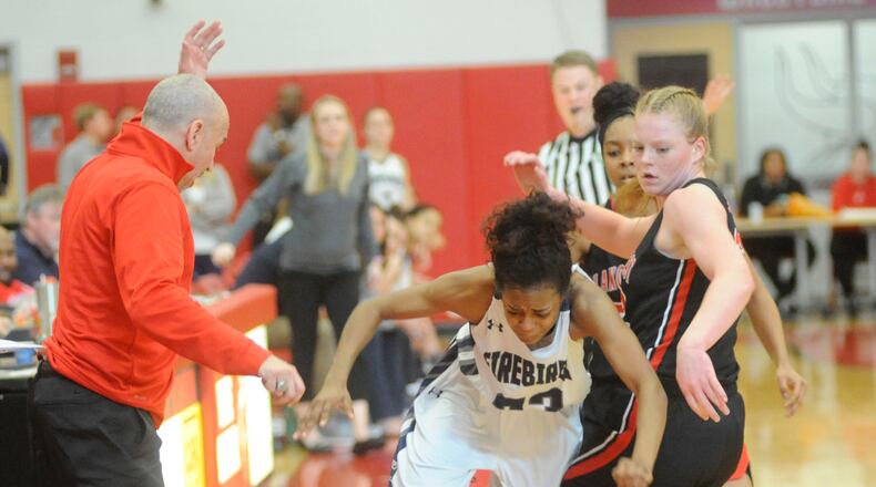 Coach Andy Fishman (left) and Abby Prohaska (right) of Lakota West watch as Makira Webster of Fairmont loses control of the ball on the sideline. Lakota West defeated Fairmont 53-29 in a girls high school basketball D-I district final at Princeton on Saturday. MARC PENDLETON / STAFF