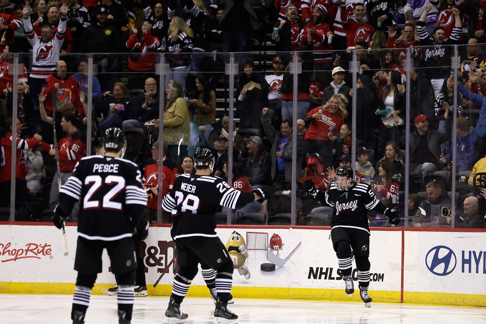 New Jersey Devils left wing Erik Haula, right, celebrates toward teammates after scoring a goal in the first period of an NHL hockey game against the Pittsburgh Penguins, Friday, April 11, 2025, in Newark, N.J. (AP Photo/Adam Hunger)
