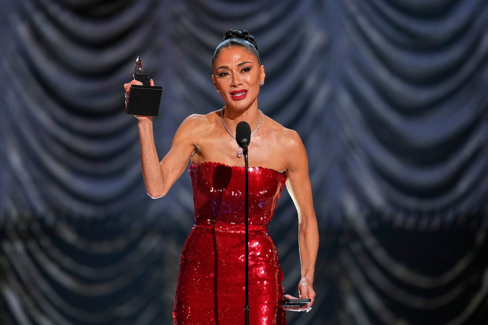 Nicole Scherzinger accepts the award for best performance by an actress in a leading role in a musical for "Sunset Blvd." during the 78th Tony Awards on Sunday, June 8, 2025, at Radio City Music Hall in New York. (Photo by Charles Sykes/Invision/AP)