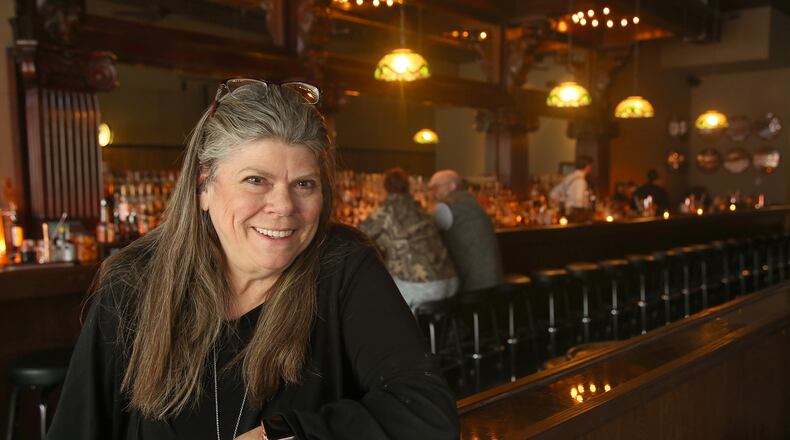 Diane Spitzig, co-owner of the Century Bar in downtown Dayton, in a photo taken shortly after the relocated bar reopened in early February. LISA POWELL / STAFF