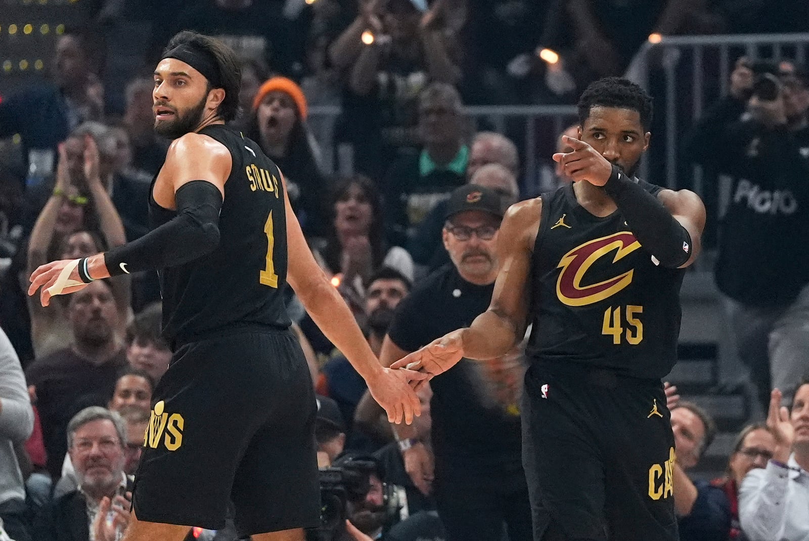 Cleveland Cavaliers guard Donovan Mitchell, right, gestures after scoring and drawing a foul as forward Obi Toppin congratulates him during the first half in Game 5 of an Eastern Conference semifinal NBA basketball playoff Tuesday, May 13, 2025, in Cleveland. (AP Photo/Sue Ogrocki)