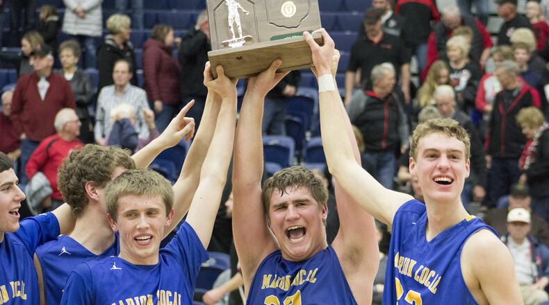 Marion Local’s Tyler Prenger (left), Tyler Mescher and Justin Albers hoist the D-IV regional trophy. Marion Local defeated Fort Loramie 62-47 in a boys high school basketball D-IV regional final at Fairmont’s Trent Arena in Kettering on Fri., March 16, 2018. JEFF GILBERT / CONTRIBUTOR