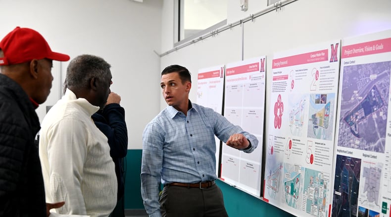 Andrew Broderick, a senior associate with Perkins and Will, the firm hired to help design the master plan of the campus expansion, speaks with attendees at an open house on Tuesday, Oct. 28, 2025, on the north end of campus. MICHAEL D. PITMAN/STAFF