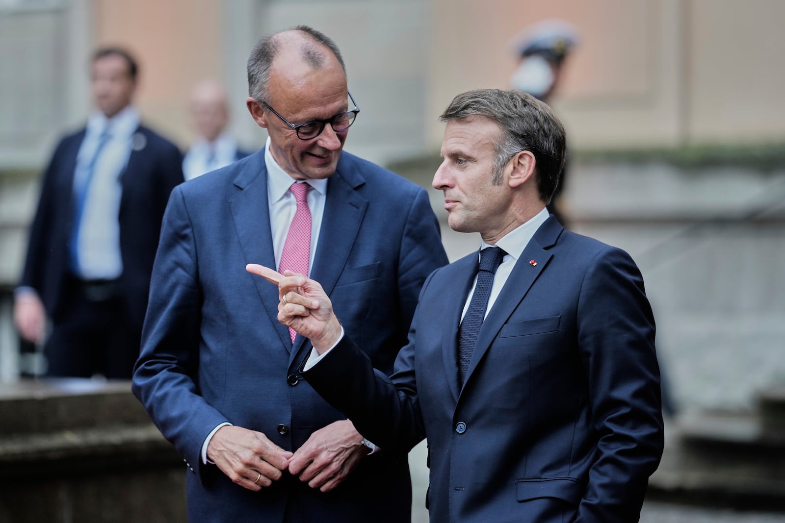 German Chancellor Friedrich Merz, left, welcomes French President Emmanuel Macron at the Foreign Ministry's guest house Villa Borsig in Berlin, Germany, Wednesday, July 23, 2025. (AP Photo/Markus Schreiber)