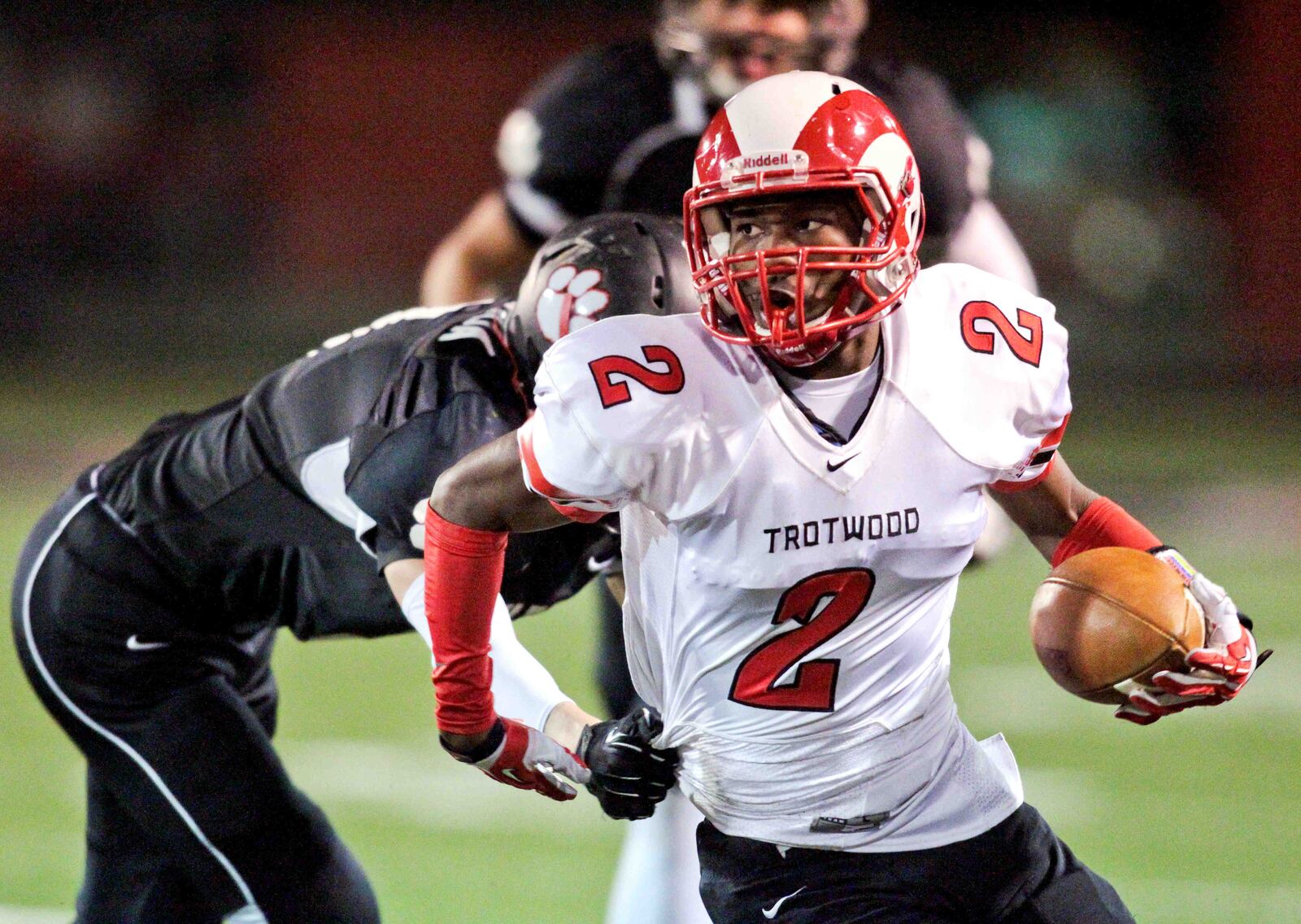Trotwood cornerback Kei Beckham (2) returns an interception during Friday night's playoff game against Franklin at Atrium Field in Franklin Nov. 8, 2013. NICK DAGGY / STAFF