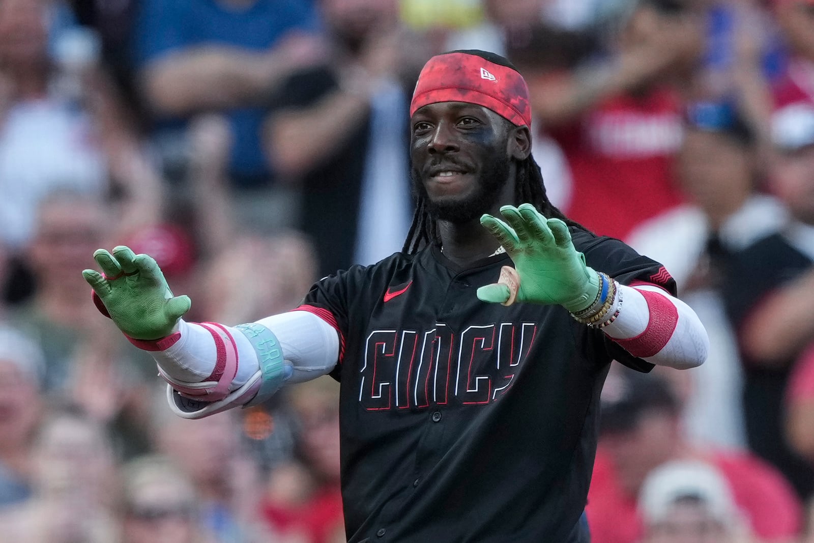 Cincinnati Reds' Elly De La Cruz reacts as he stands on third base after hitting a triple during the third inning of a baseball game against the Colorado Rockies in Cincinnati, Friday, July 11, 2025. (AP Photo/Carolyn Kaster)
