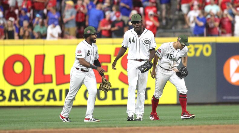 Reds outfielders Phillip Ervin, Aristides Aquino and Nick Senzel celebrate after a victory against the Cubs on Friday, Aug. 9, 2019, at Great American Ball Park in Cincinnati.