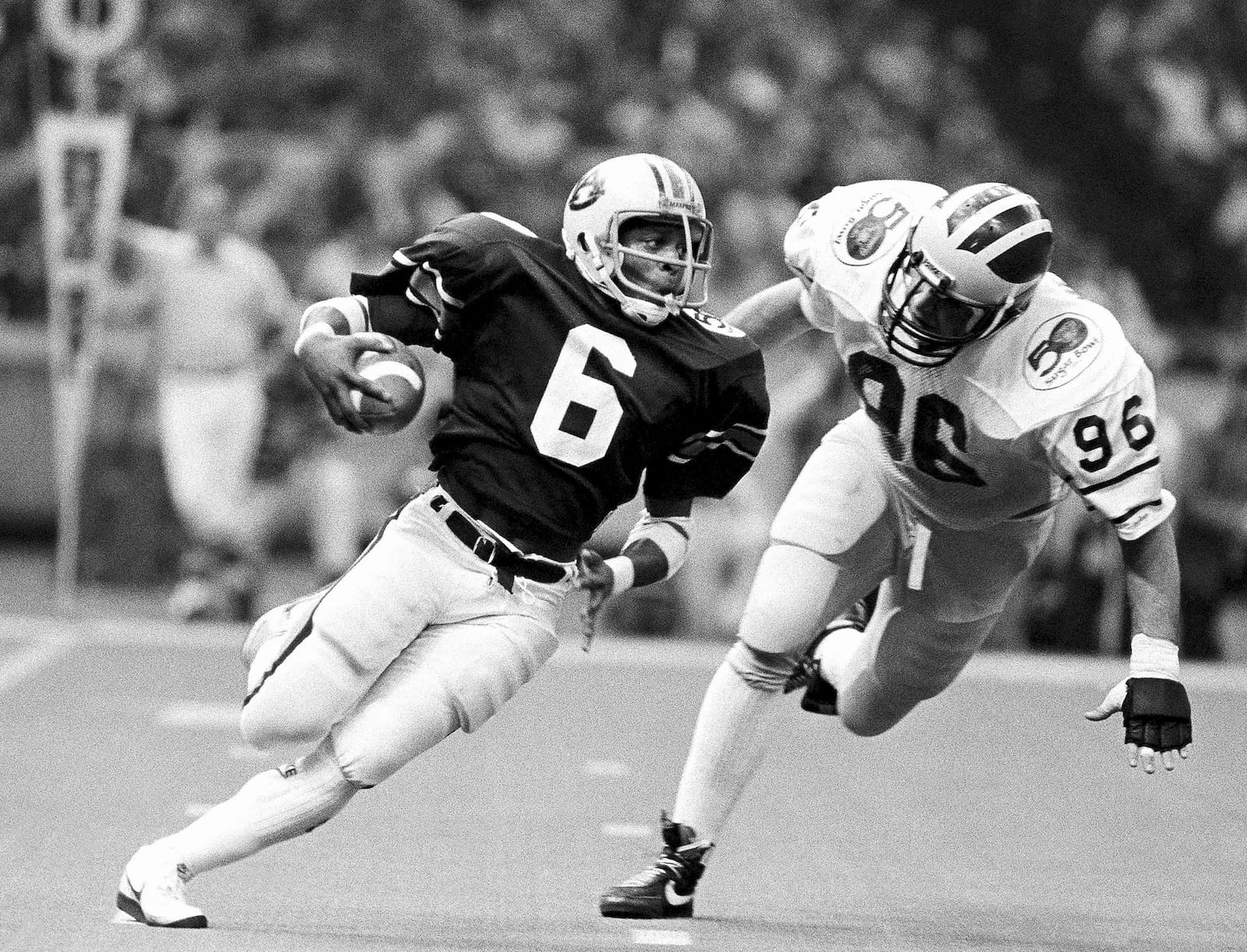 FILE - Auburn's Lionel James, (6) gains yardage as Michigan's Dave Meredith (96) tries to stop him in NCAA college football Sugar Bowl action in New Orleans, Jan. 2, 1984. (AP Photo, file)