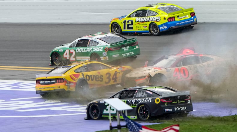 Riley Herbst, (35), Justin Allgaier, (40), Todd Gilliland, (34), John Hunter Nemechek, (42) and Ryan Blaney, (12) collide during the NASCAR Daytona 500 auto race at Daytona International Speedway, Sunday, Feb. 15, 2026, in Daytona Beach, Fla. (AP Photo/John Raoux)