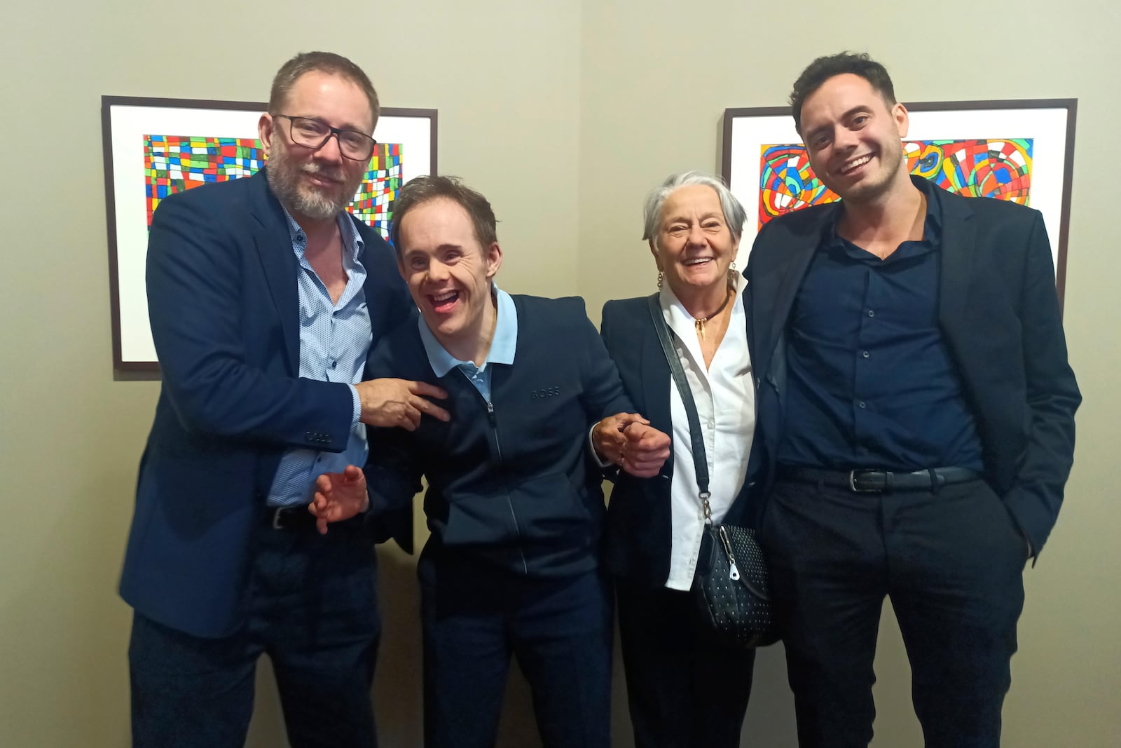 Brazilian photographer and environmentalist Sebastiao Salgado's wife Lelia Salgado poses with her sons Rodrigo Salgado, second left, and Juliano Salgago, left, and with family member Flavio Salgado, Saturday, May 24, 2025 in Reims, eastern France, one day after Sebastiao Salgado died at 81. (AP Photo/Boubkar Benzabat)
