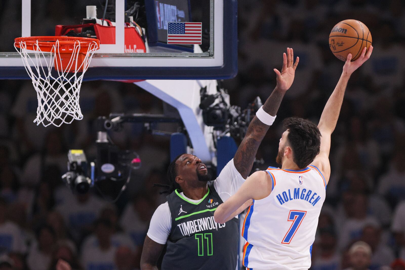 Oklahoma City Thunder forward Chet Holmgren (7) shoots against Minnesota Timberwolves center Naz Reid (11) during the first half of Game 1 of an NBA basketball Western Conference Finals playoff series Tuesday, May 20, 2025, in Oklahoma City. (AP Photo/Nate Billings)