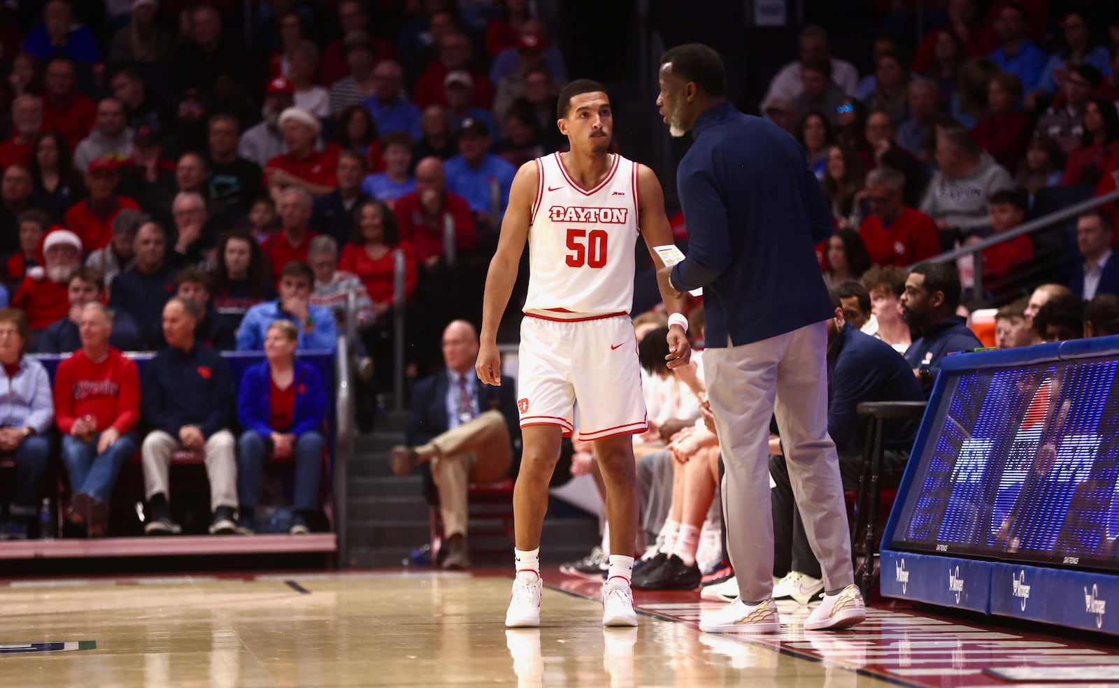 Dayton's Anthony Grant, right, talks to Sean Pouedet during a game against Liberty on Saturday, Dec. 20, 2025, at UD Arena. David Jablonski/Staff