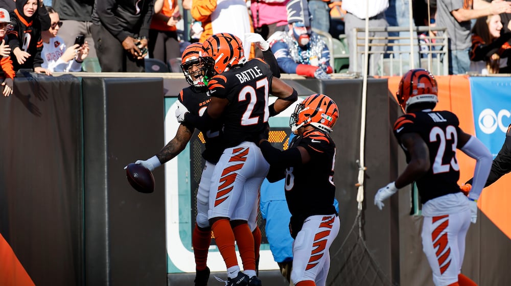Cincinnati Bengals safety Geno Stone, left, celebrates with teammates after returning an interception for a touchdown during the first half of an NFL football game against the New England Patriots, Sunday, Nov. 23, 2025, in Cincinnati. (AP Photo/Jay LaPrete)