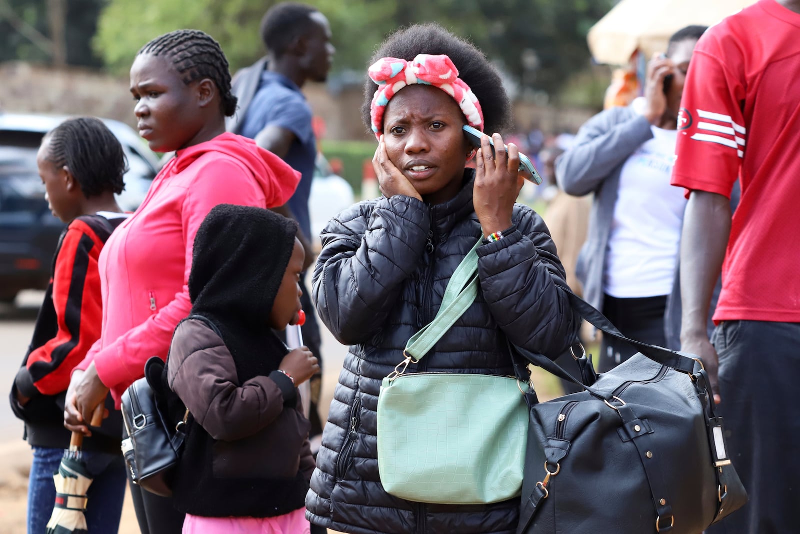 A woman talks on her mobile phone in downtown Nairobi, Kenya, Sept. 13, 2025. (AP Photo/Andrew Kasuku)