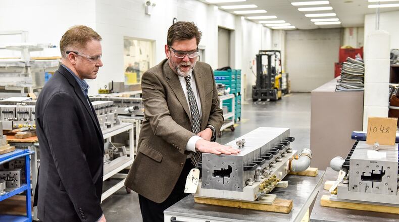 Jon Hauberg, right, shows U.S. Rep. Warren Davidson, R-Troy, equipment during a tour of Monroe’s Deceuninck North America in March. NICK GRAHAM/STAFF