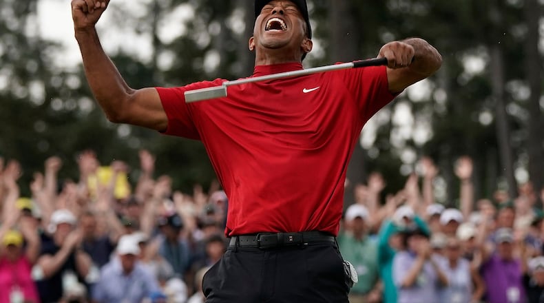 FILE - Tiger Woods reacts as he wins the Masters golf tournament, Sunday, April 14, 2019, in Augusta, Ga. (AP Photo/David J. Phillip, File)