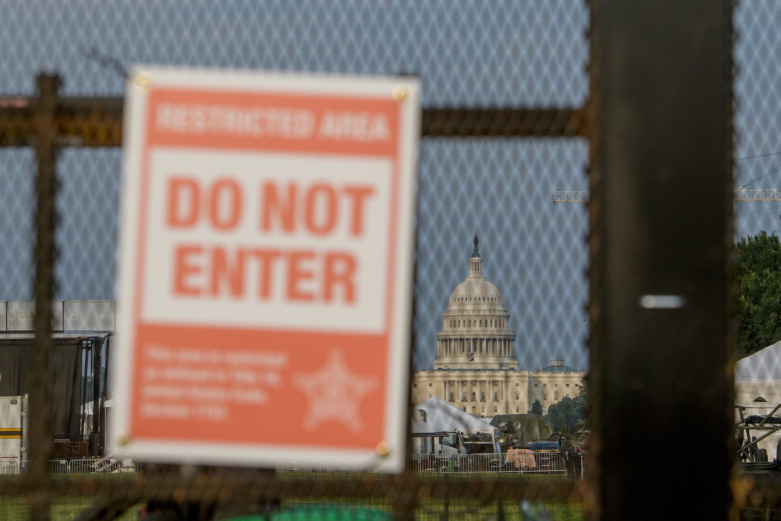 The U.S. Capitol is seen through security fencing, set up on the National Mall, during preparations for an upcoming military parade commemorating the Army's 250th anniversary and coinciding with President Donald Trump's 79th birthday, Thursday, June 12, 2025, in Washington. (AP Photo/Rod Lamkey, Jr.)