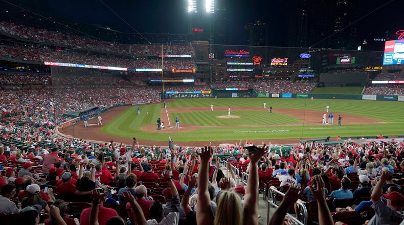 Fans do The Wave as the St. Louis Cardinals play the Chicago Cubs during the sixth inning of a baseball game Friday, May 21, 2021, in St. Louis. Capacity inside Busch Stadium has been increased for the series and and will be increased to capacity starting June 14 as coronavirus restrictions are lifted. (AP Photo/Jeff Roberson)