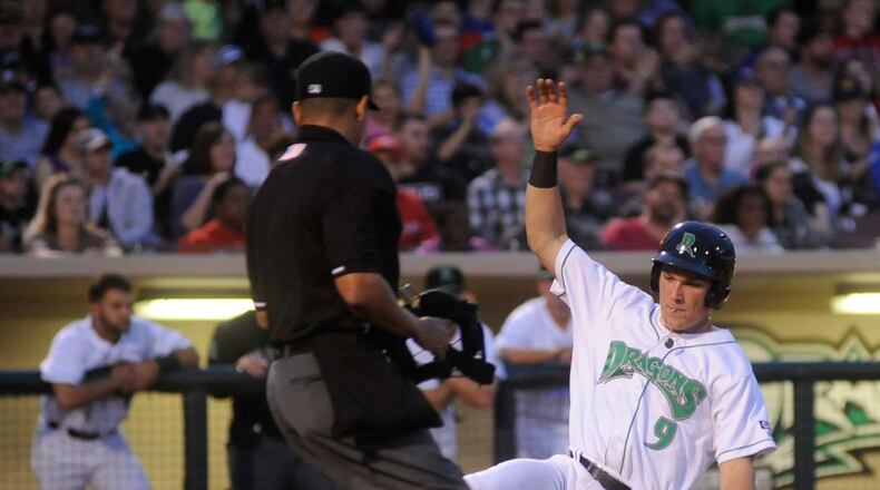 Dragons catcher Tyler Stephenson slides home to score in the fifth inning. The Dragons hosted the Lansing Lugnuts (Blue Jays) in a Midwest League Class A minor-league baseball game at Dayton’s Fifth Third Field on Tuesday, April 18, 2017. MARC PENDLETON / STAFF