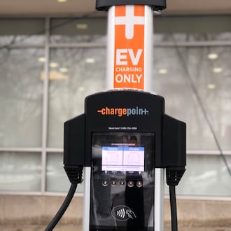 An electric vehicle charging station in downtown Dayton. CORNELIUS FROLIK / STAFF