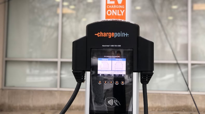 An electric vehicle charging station in downtown Dayton. CORNELIUS FROLIK / STAFF