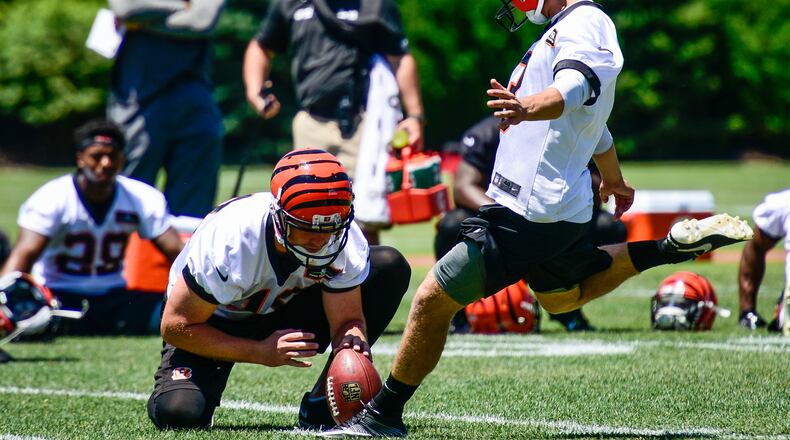 Cincinnati Bengals kicker Jake Elliott kicks a field goal as the ball is held by punter Kevin Huber during practice Tuesday, June 6 on their practice fields next to Paul Brown Stadium in Cincinnati. NICK GRAHAM/STAFF
