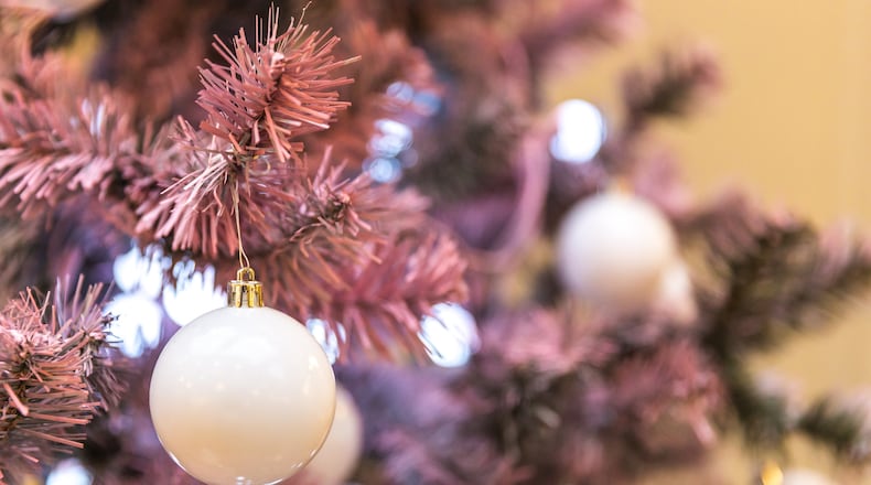 Pink holiday decor is popular this season as some are purchasing pink artificial Christmas trees and decorating with more glam. iSTOCK/COX