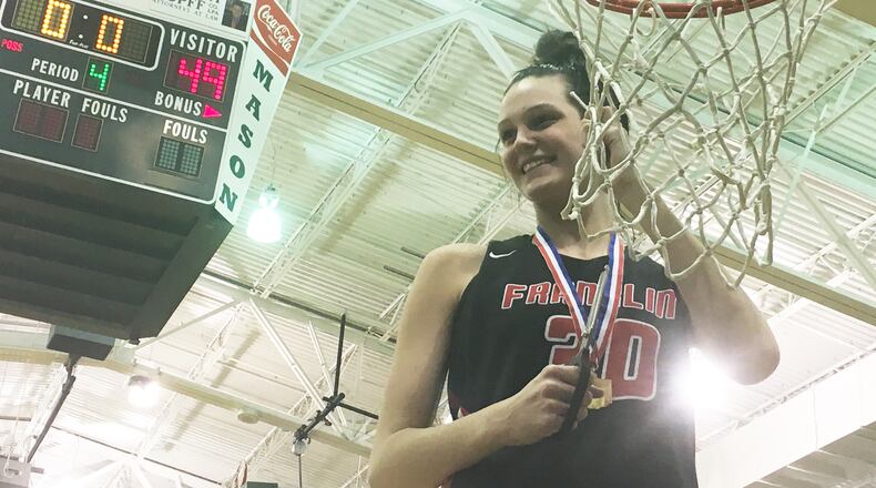 Franklin’s Layne Ferrell savors the chance to cut down the net Friday night after the Wildcats defeated Tippecanoe 49-39 in a Division II district championship basketball game at Mason Arena. RICK CASSANO/STAFF