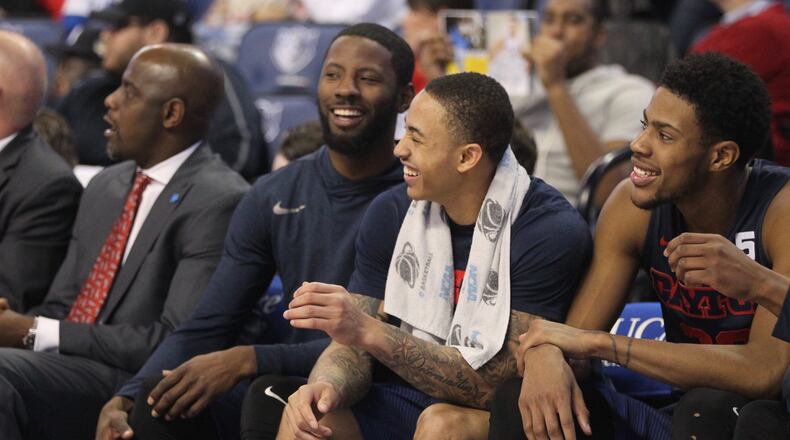 Dayton's Scoochie Smith, Kyle Davis and Xeyrius Williams share a laugh on the bench during a game against Saint Louis on Feb. 14, 2017.